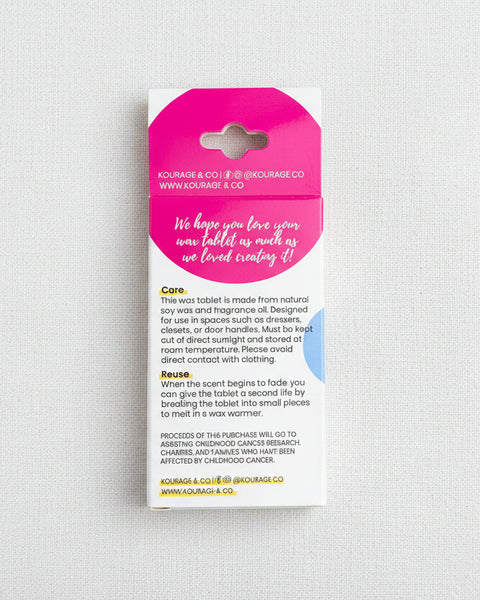 Pink wax tablet packaging with text on a textured beige background