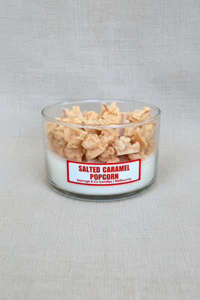 Candle with salted caramel popcorn inside on a burlap background