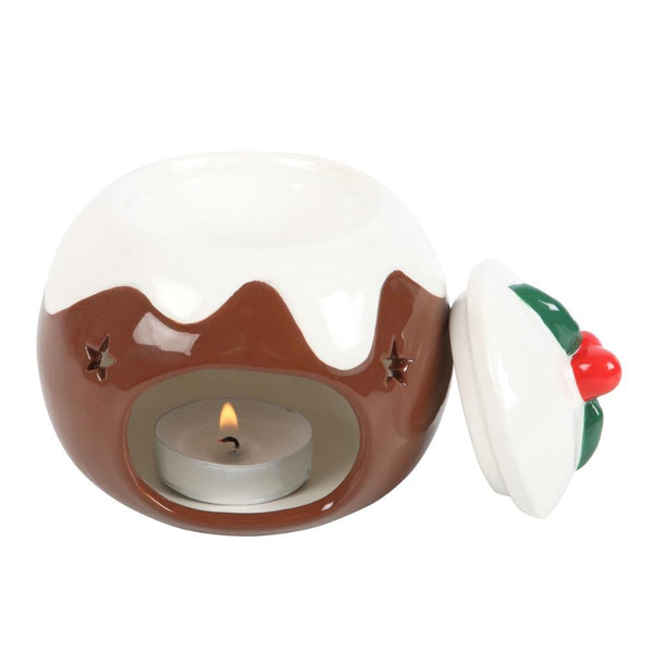 Ceramic Christmas pudding with a lit tealight candle on a white background