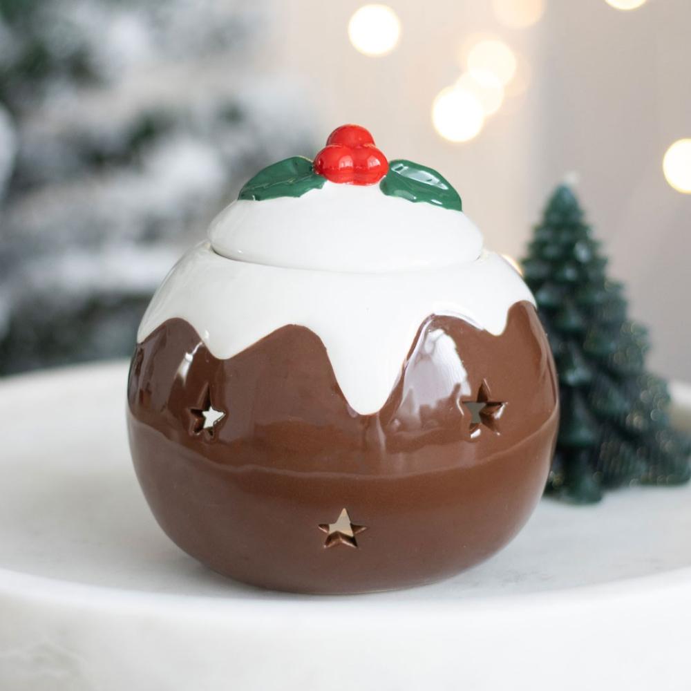 Decorative Christmas pudding ornament with a star on a white surface.