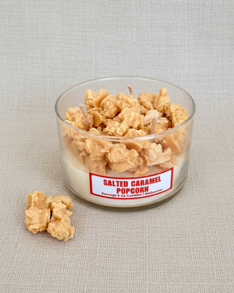 Glass container of salted caramel popcorn with a label on a burlap background