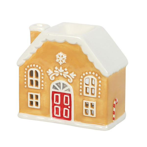 Decorative gingerbread house with a red door on a white background