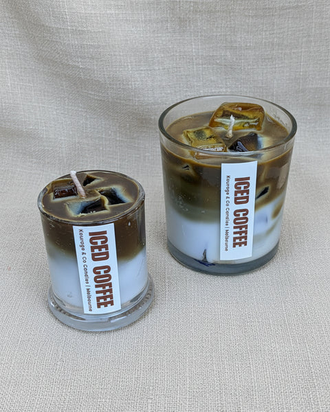 Two glass containers with 'iced coffee' labels on a textured beige background